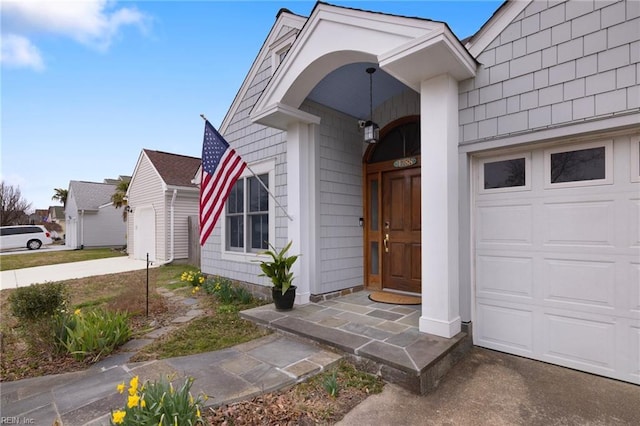 view of exterior entry featuring an attached garage