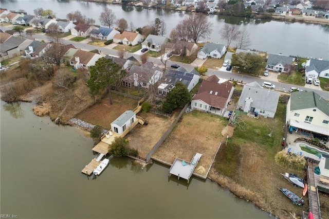 drone / aerial view with a residential view and a water view