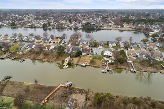 drone / aerial view with a residential view and a water view