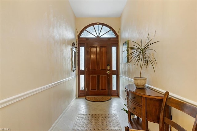 tiled foyer entrance with baseboards