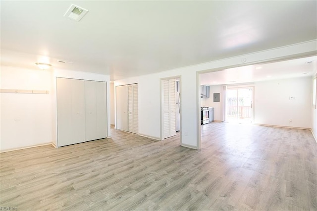 spare room with visible vents, baseboards, and light wood-style floors