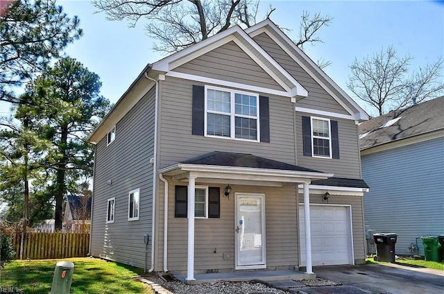 traditional home featuring an attached garage, driveway, and fence