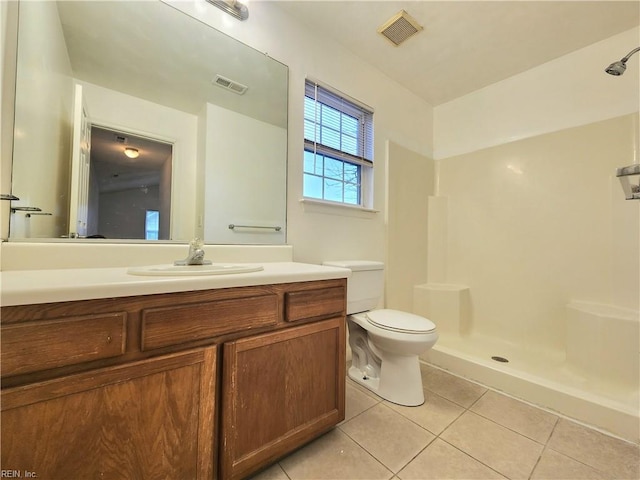 bathroom with tile patterned flooring, toilet, visible vents, and walk in shower