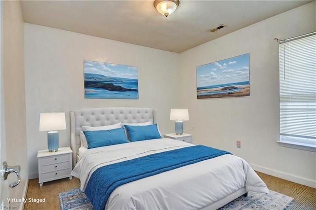 bedroom featuring visible vents and baseboards