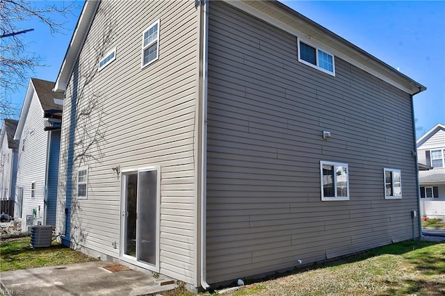 view of side of property with central air condition unit