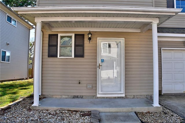 view of exterior entry with a garage