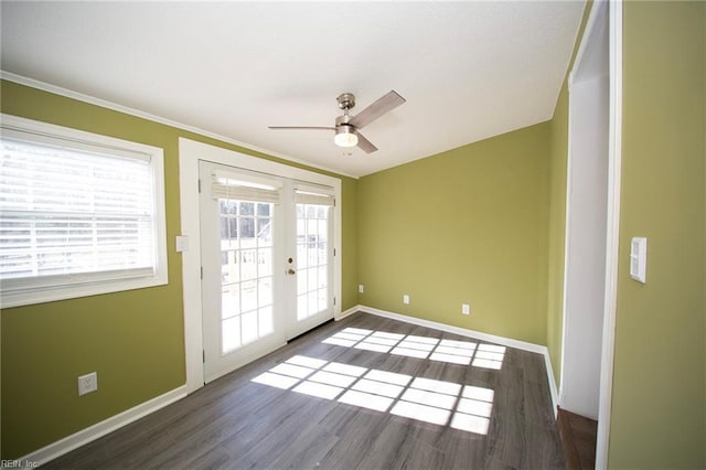 spare room with french doors, baseboards, and wood finished floors