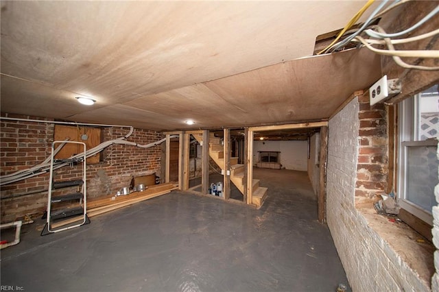 basement featuring brick wall