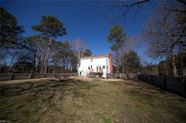 view of yard with entry steps and a fenced backyard