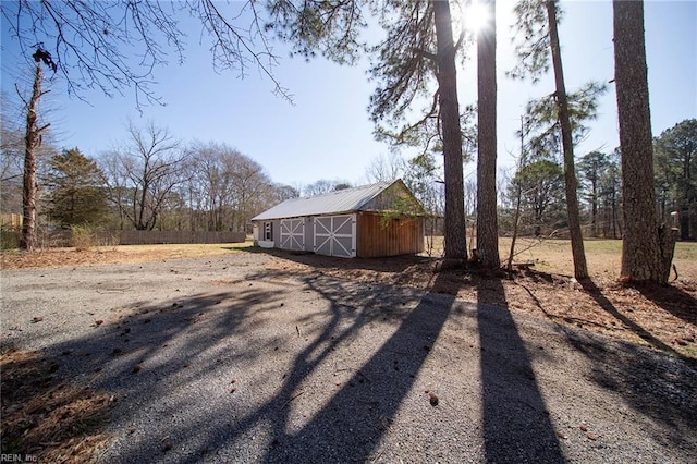 view of yard featuring an outbuilding, a barn, and a garage