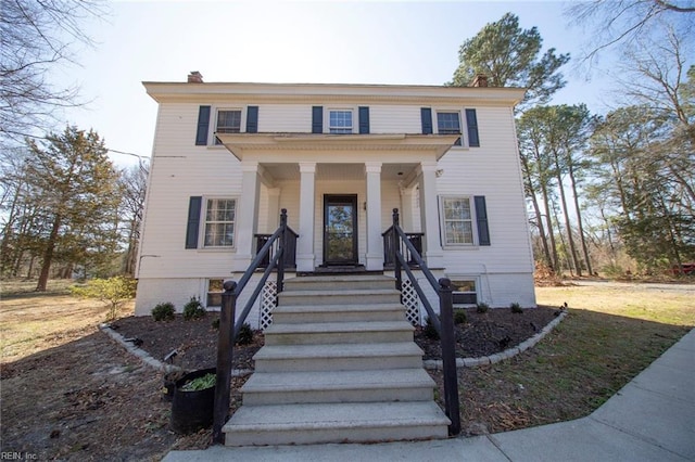 view of front of property featuring a porch and a chimney