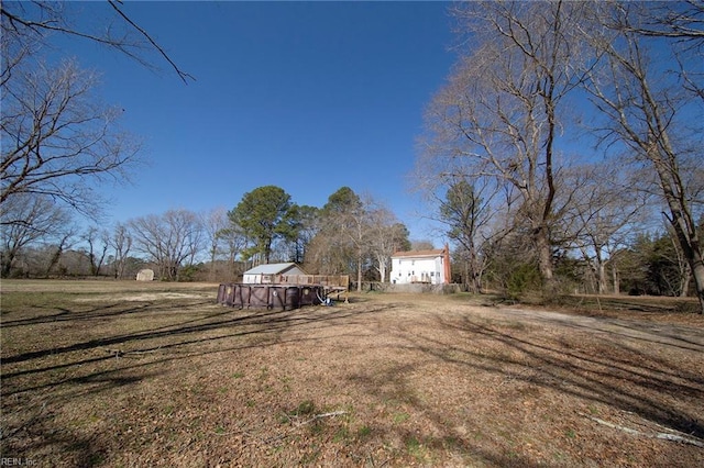 view of yard featuring a rural view and a garage