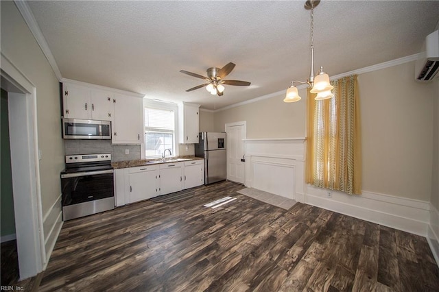 kitchen featuring crown molding, white cabinets, dark wood-type flooring, and stainless steel appliances