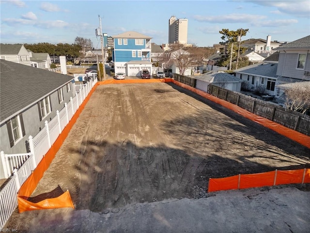 view of yard featuring a residential view and fence