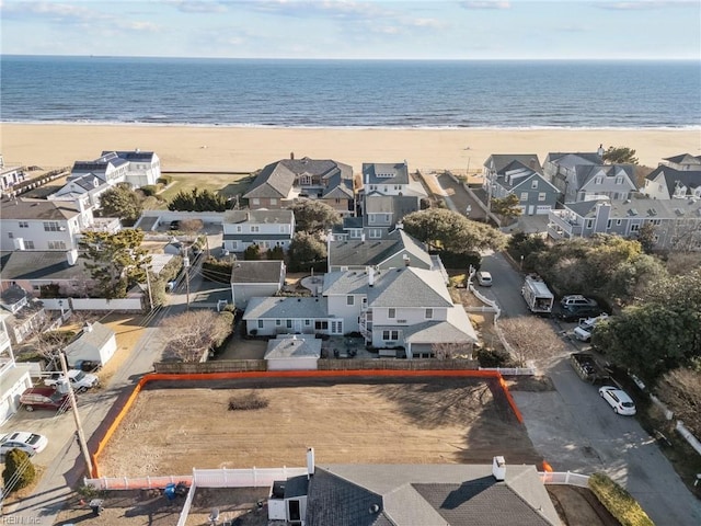 birds eye view of property with a beach view, a residential view, and a water view