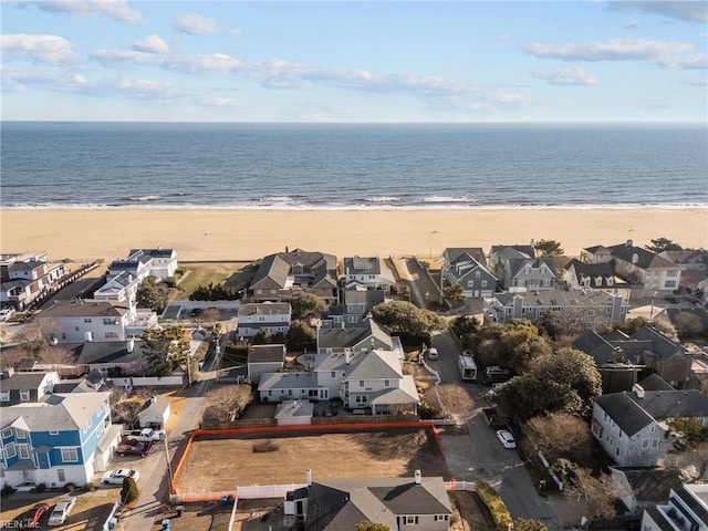 bird's eye view with a water view, a beach view, and a residential view