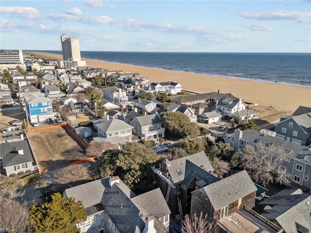 bird's eye view featuring a view of the beach and a water view