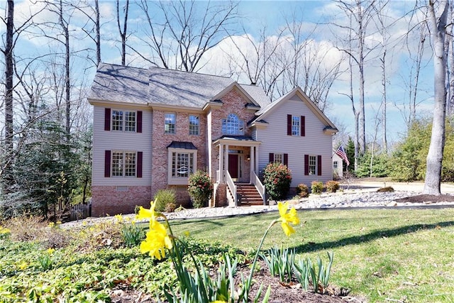 view of front of home featuring brick siding and a front lawn