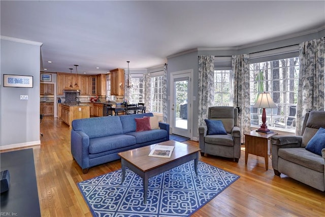 living area with recessed lighting, baseboards, light wood finished floors, and ornamental molding