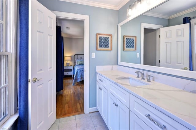 bathroom featuring connected bathroom, baseboards, ornamental molding, tile patterned floors, and vanity