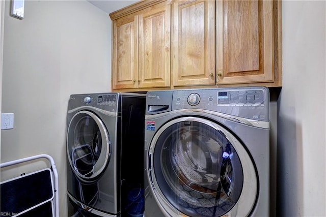 laundry room featuring cabinet space and washing machine and clothes dryer