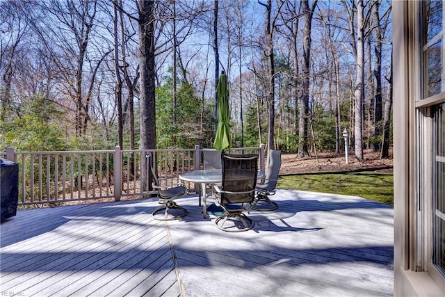 wooden deck featuring outdoor dining area