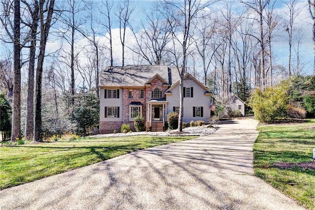 view of front of property with a front yard and driveway