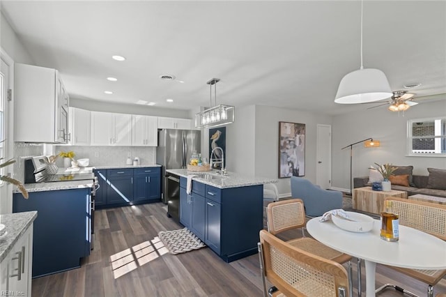 kitchen with blue cabinetry, range with electric cooktop, dark wood-type flooring, open floor plan, and dishwasher