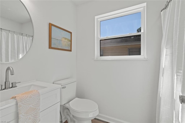 full bath with vanity, toilet, and baseboards