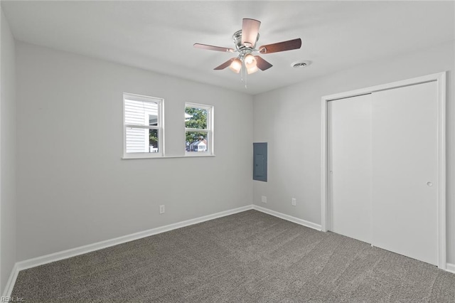 unfurnished bedroom featuring visible vents, baseboards, carpet floors, electric panel, and a closet