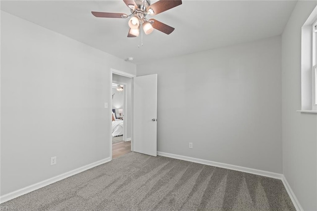 unfurnished bedroom featuring carpet flooring, a ceiling fan, and baseboards