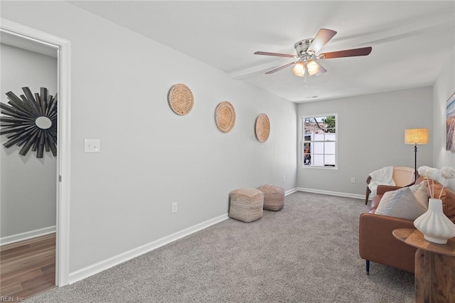 living area with baseboards, carpet floors, and ceiling fan