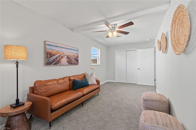 carpeted living room featuring beam ceiling, a ceiling fan, and baseboards