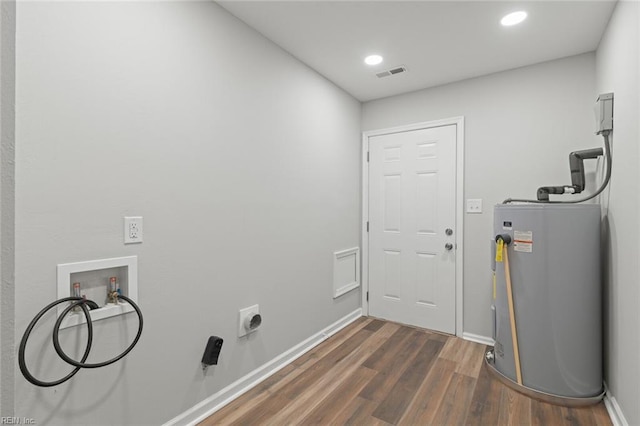 washroom featuring visible vents, laundry area, dark wood-style flooring, washer hookup, and electric water heater