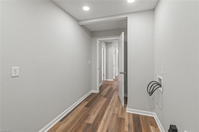 corridor with baseboards and dark wood-style flooring