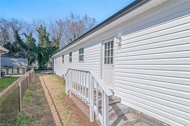 view of side of property featuring fence