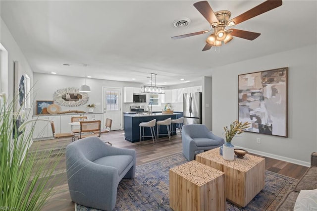 living room with visible vents, baseboards, dark wood finished floors, recessed lighting, and a ceiling fan