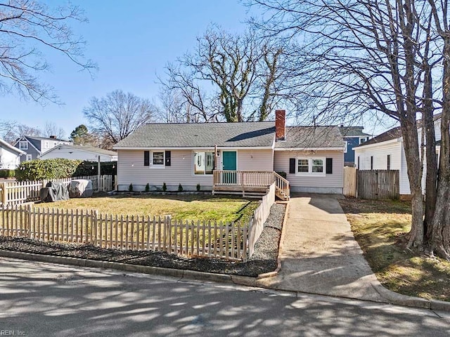 ranch-style house with a fenced front yard, a chimney, concrete driveway, and a front lawn