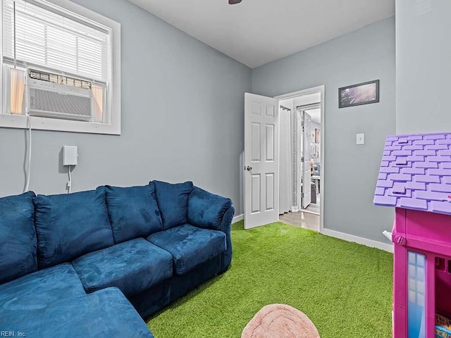 living area featuring cooling unit, baseboards, and carpet floors