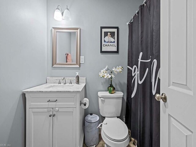 full bathroom featuring toilet and vanity