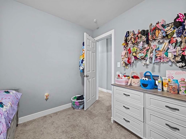 bedroom with baseboards and light carpet