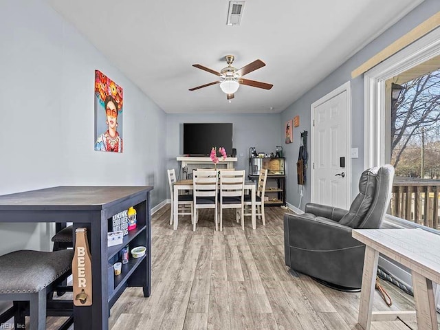 interior space with visible vents, baseboards, light wood-style floors, and ceiling fan