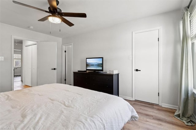 bedroom with baseboards, light wood finished floors, and ceiling fan