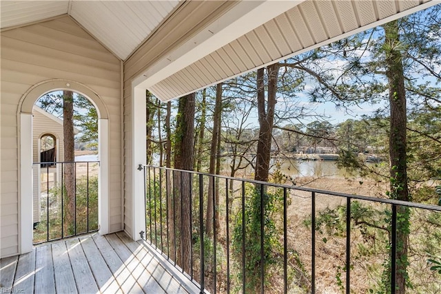 exterior space with a water view and vaulted ceiling