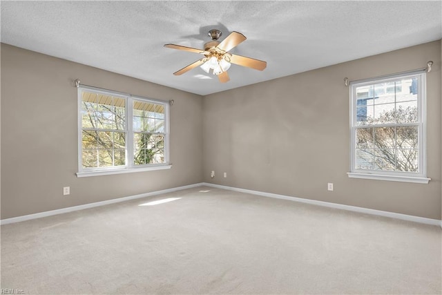 empty room with baseboards, a textured ceiling, and carpet flooring