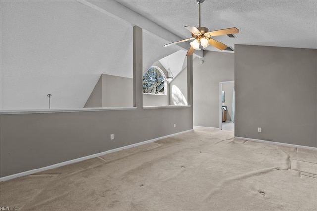 carpeted empty room featuring a textured ceiling, lofted ceiling, baseboards, and ceiling fan