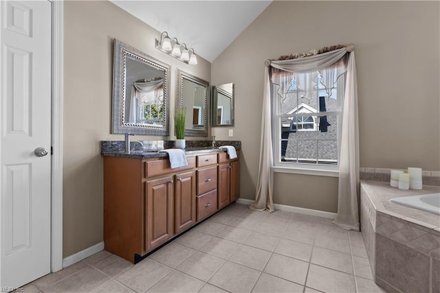 full bathroom featuring lofted ceiling, double vanity, tiled bath, and tile patterned floors