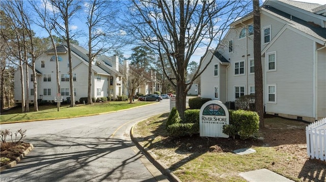 view of road featuring a residential view and curbs