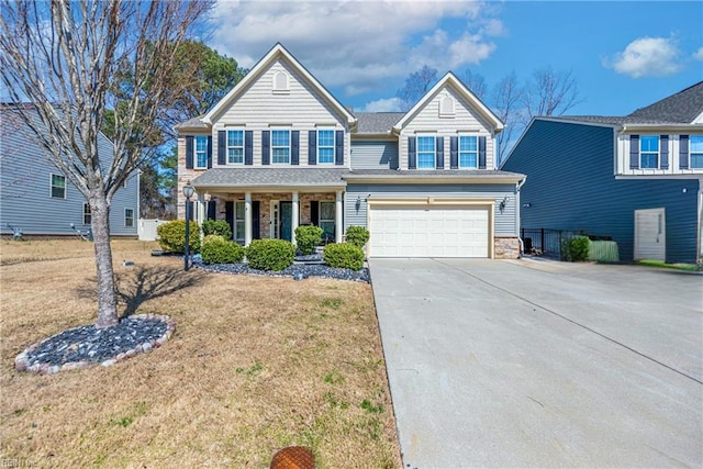 traditional-style house with stone siding, an attached garage, driveway, and a front lawn