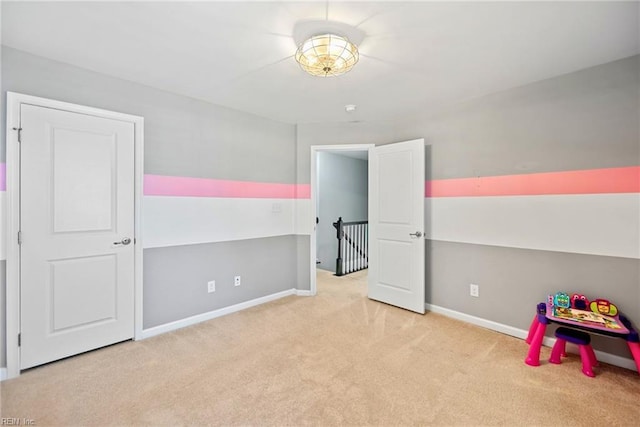 carpeted bedroom featuring baseboards